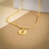 Zoom sur un pendentif doré gravé avec la lettre Z et une date