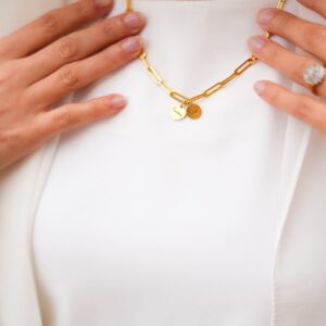 deux pendentif sur le bijou à anneaus - collier - porté sur vêtement blancs