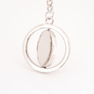 Porte clé argent, sur fond blanc. Disque tournoyant sur lui même à personnaliser avec gravure