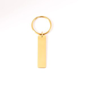 porte clé doré à personnalisé posé sur fond blanc